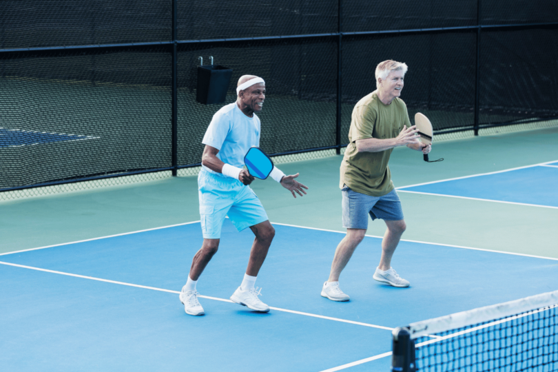 Two pickleball players executing a strategic play