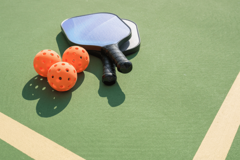 Guide on buying a pickleball paddle, showing various paddle options and features to consider