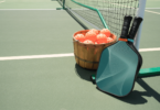 A collection of pickleball paddles on a court