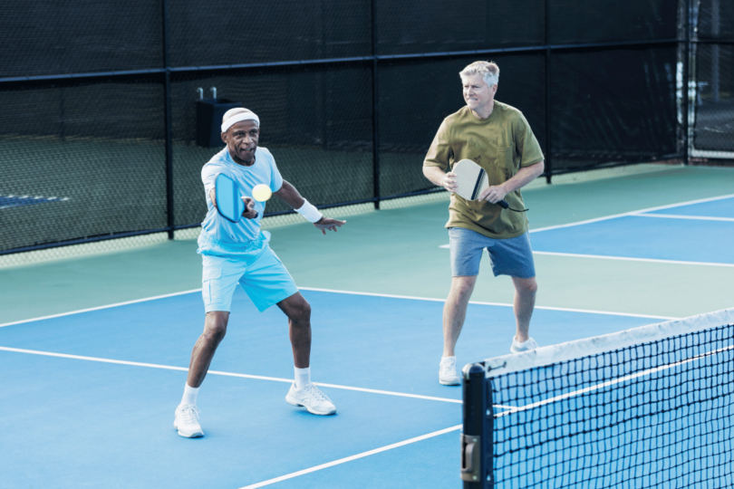 Player performing a successful dink shot in pickleball