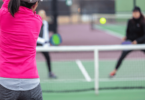 Pickleball player serving on court with proper technique.